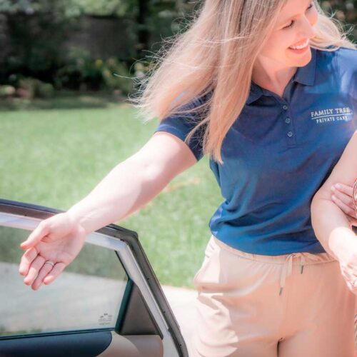 Staff assisting a resident at a vehicle