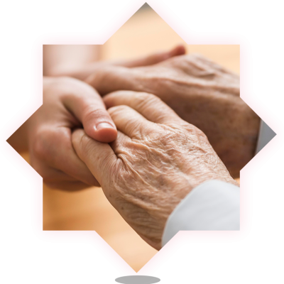 Close-up of hands between a caregiver and an elderly person.