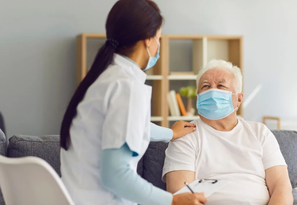 Caregiver talking to a resident in a cozy setting.