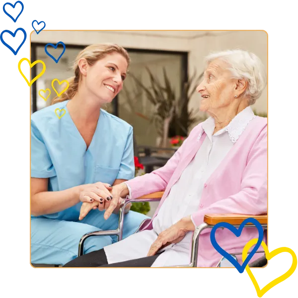 Caregiver interacting with a senior resident outdoors.
