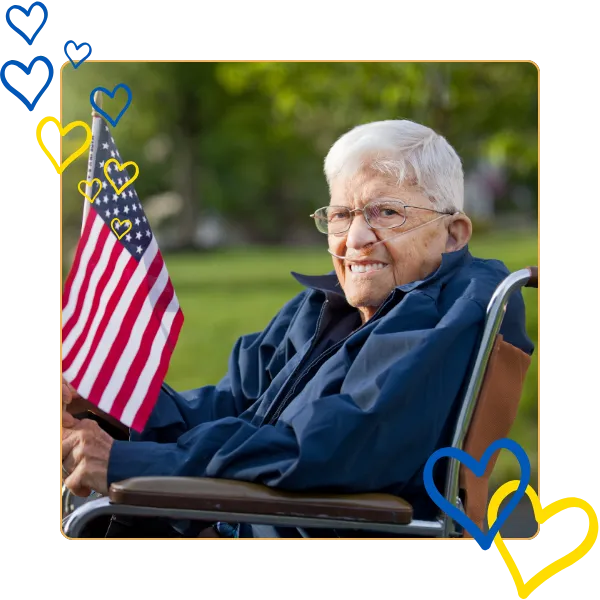 Elderly man waving an American flag outdoors