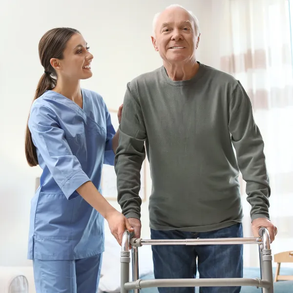 Staff assisting a resident with a walker.