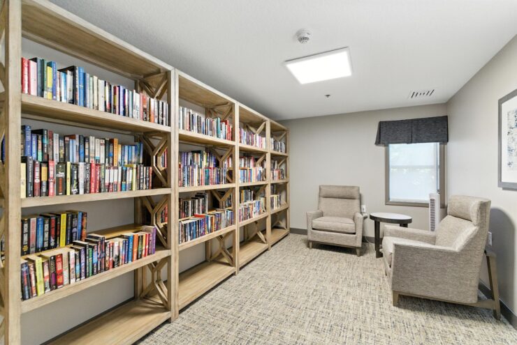 Cozy reading area with bookshelves and chairs.