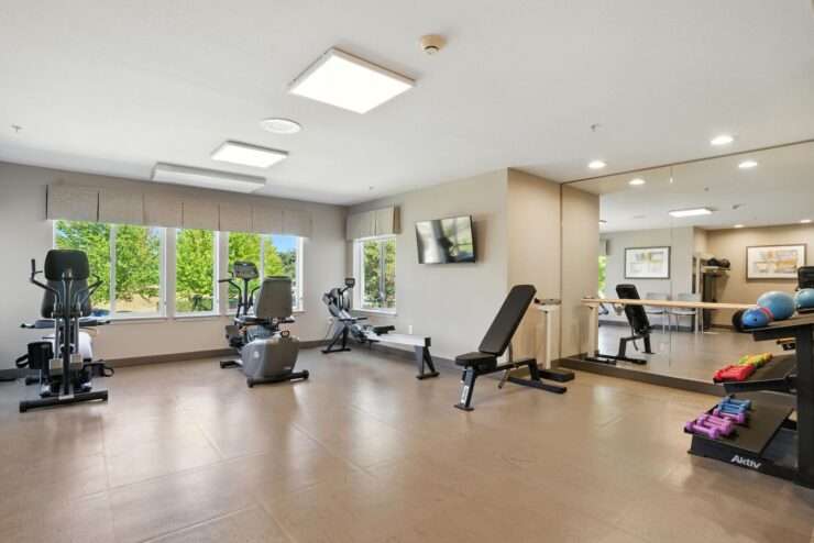 Fitness center with exercise equipment and large windows