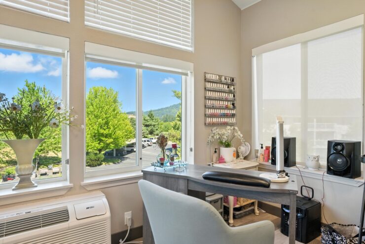 Bright salon room with windows and manicure supplies.