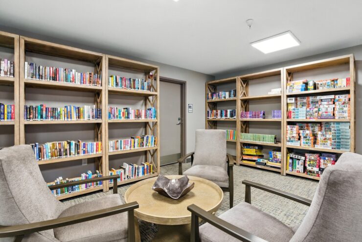 Cozy common area with bookshelves and seating.