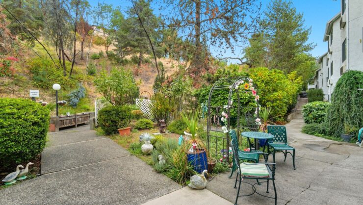 Charming garden area with seating and decorative elements.