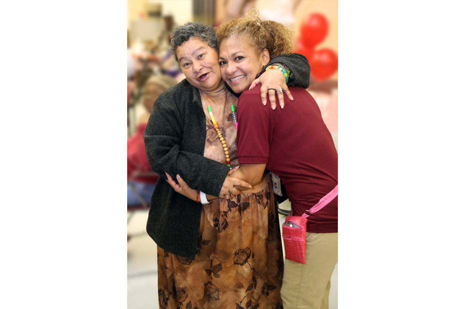 Resident and staff member sharing a joyful moment