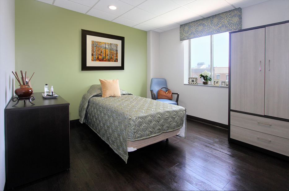 A cozy resident room with a bed and window