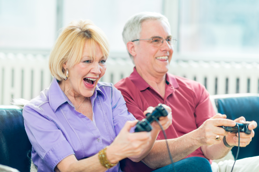 Two seniors enjoying a video game together
