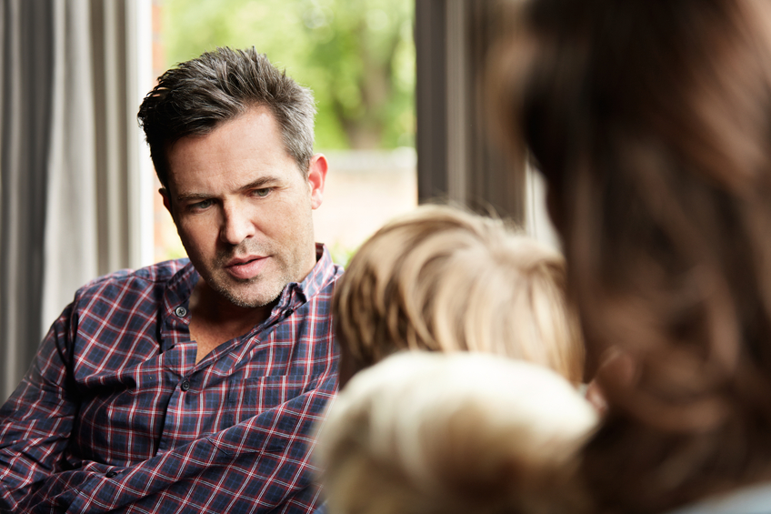 Man interacting with children in a cozy setting.