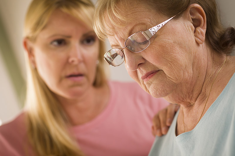 Caregiver assisting an elderly woman