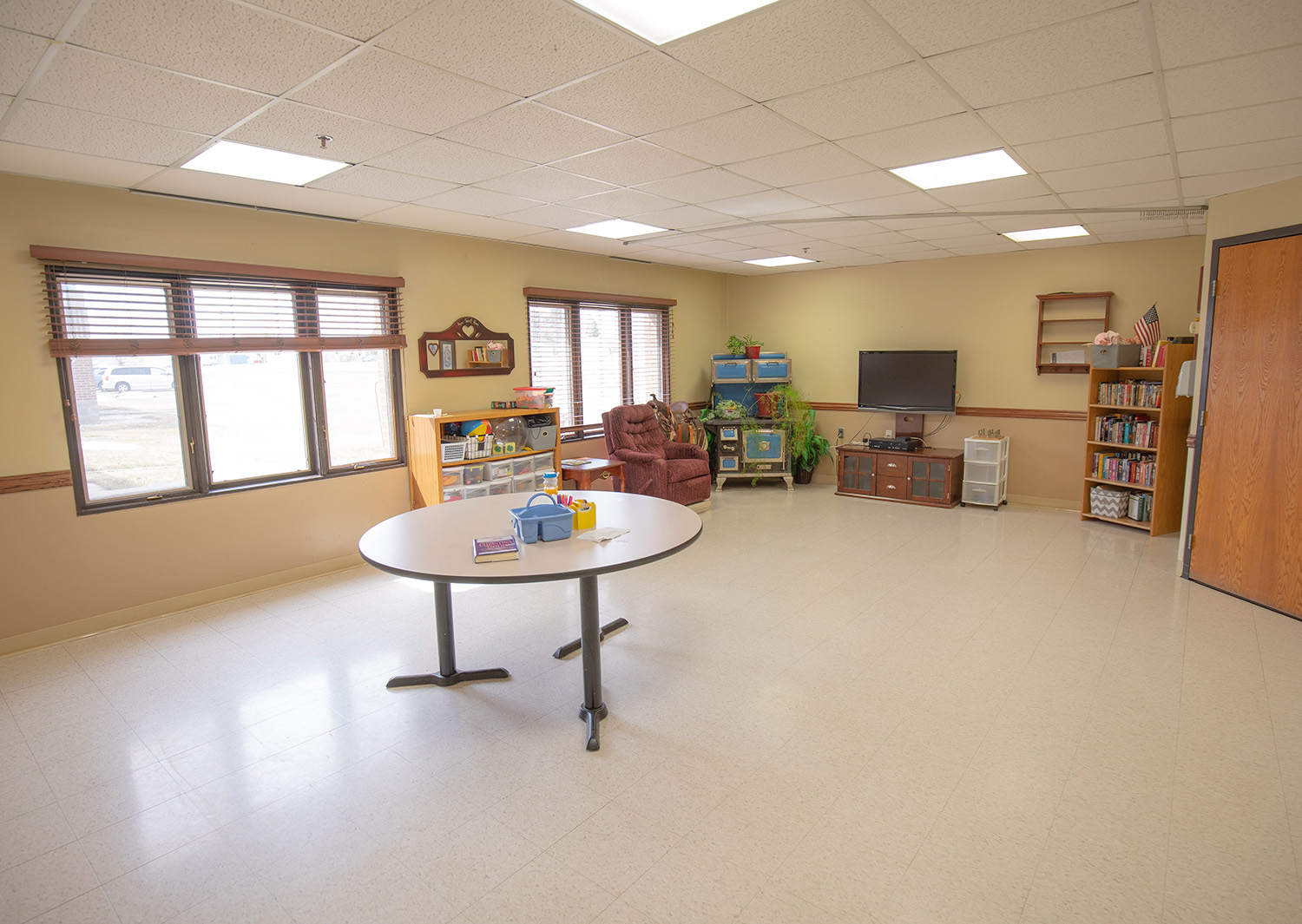 Bright common area with seating and shelves