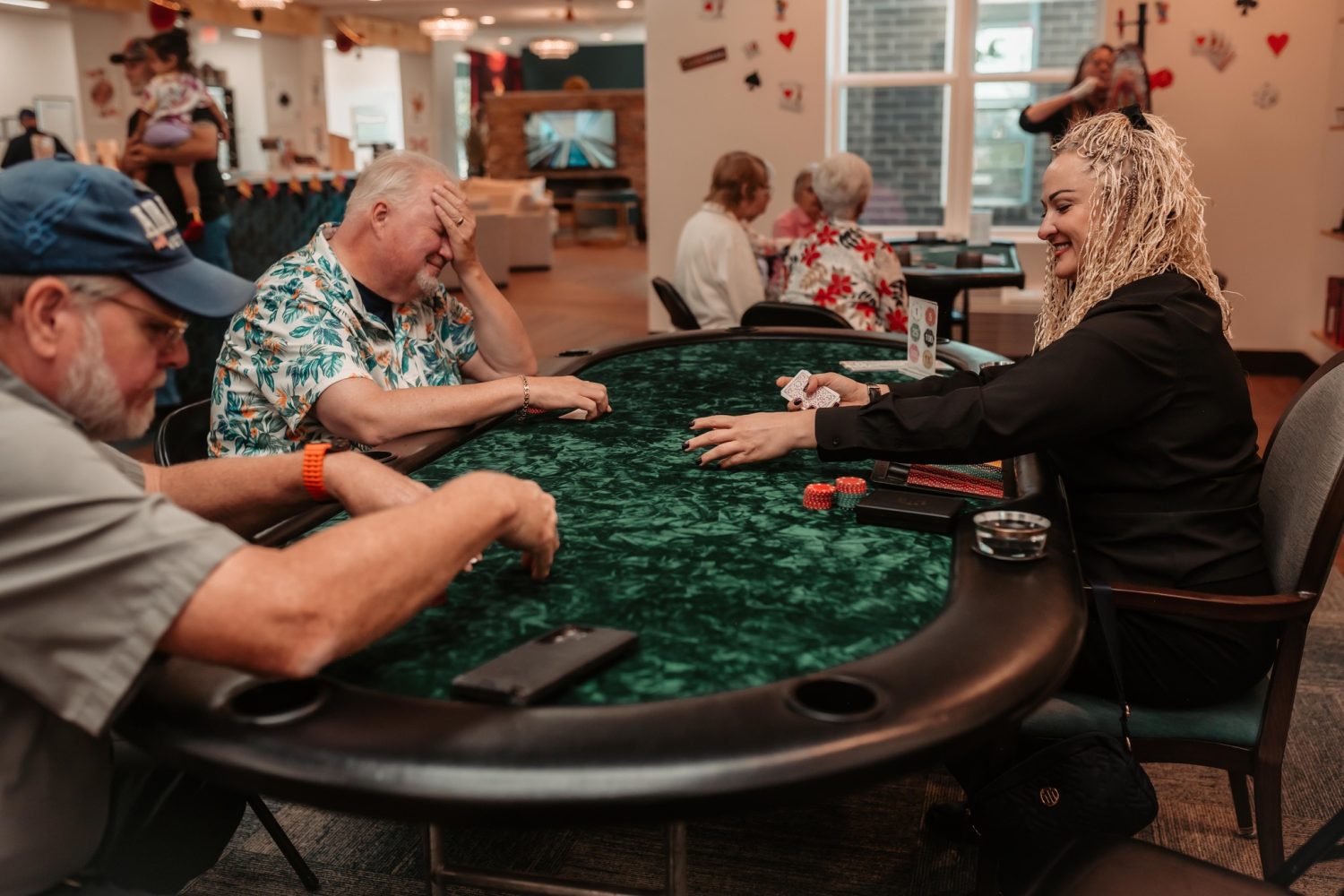 Residents enjoying a poker game in a common area