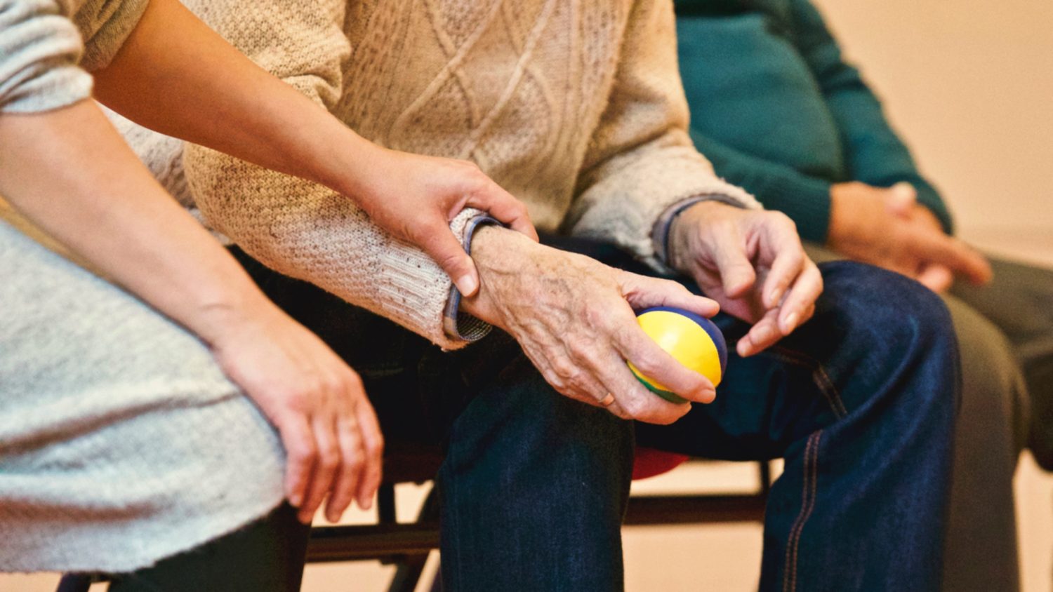 A caregiver assisting a senior resident during an activity