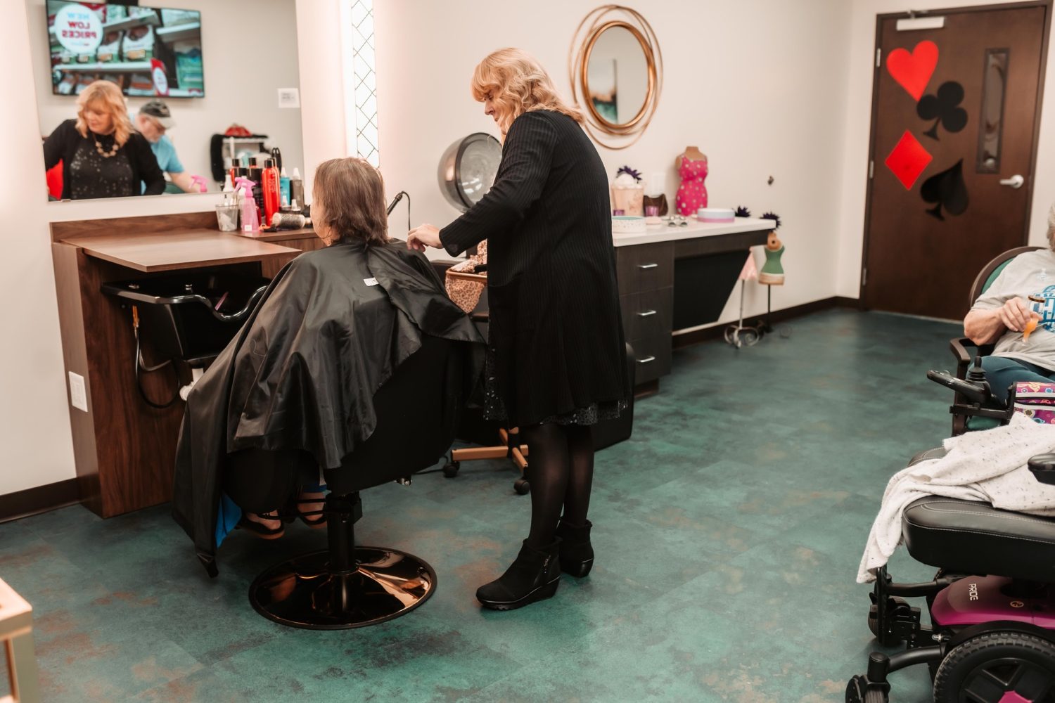 Resident receiving a hair treatment in the salon