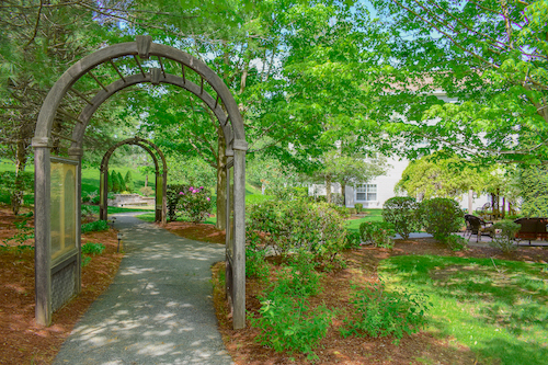 Pathway through a landscaped garden at a senior living facility