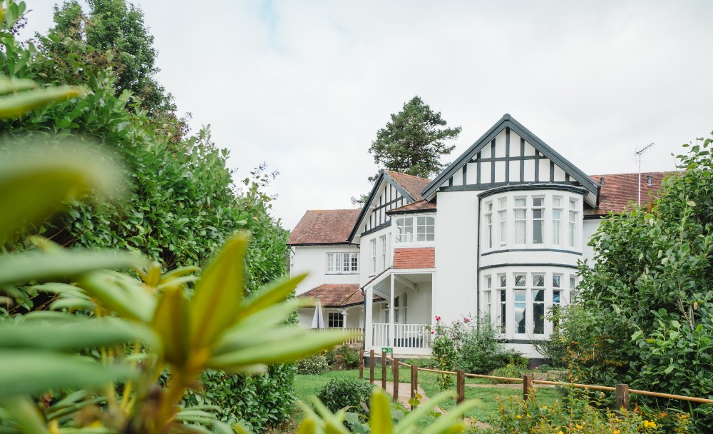 Exterior view of a residential home with gardens