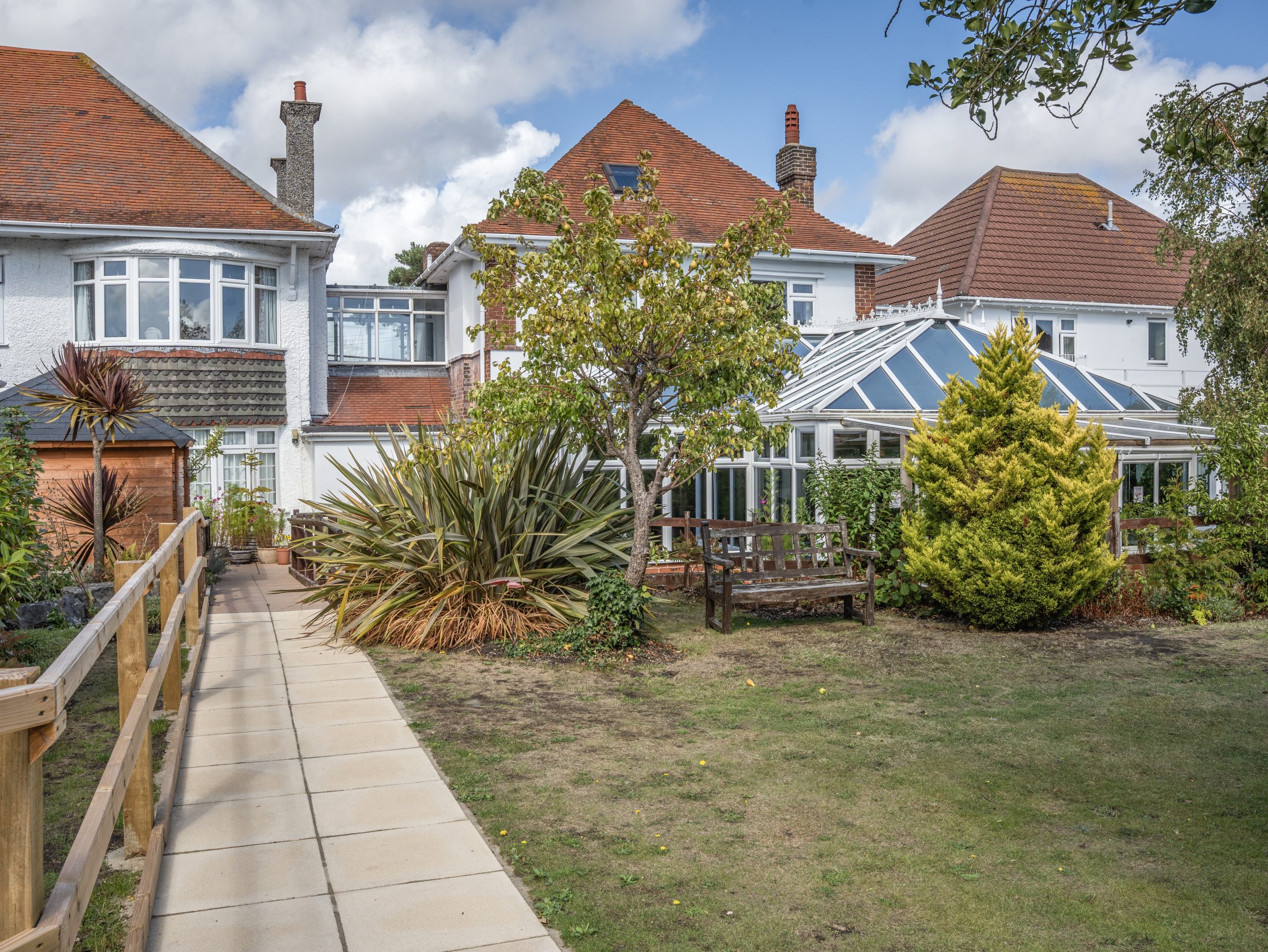 Exterior view of a residential home with garden pathways