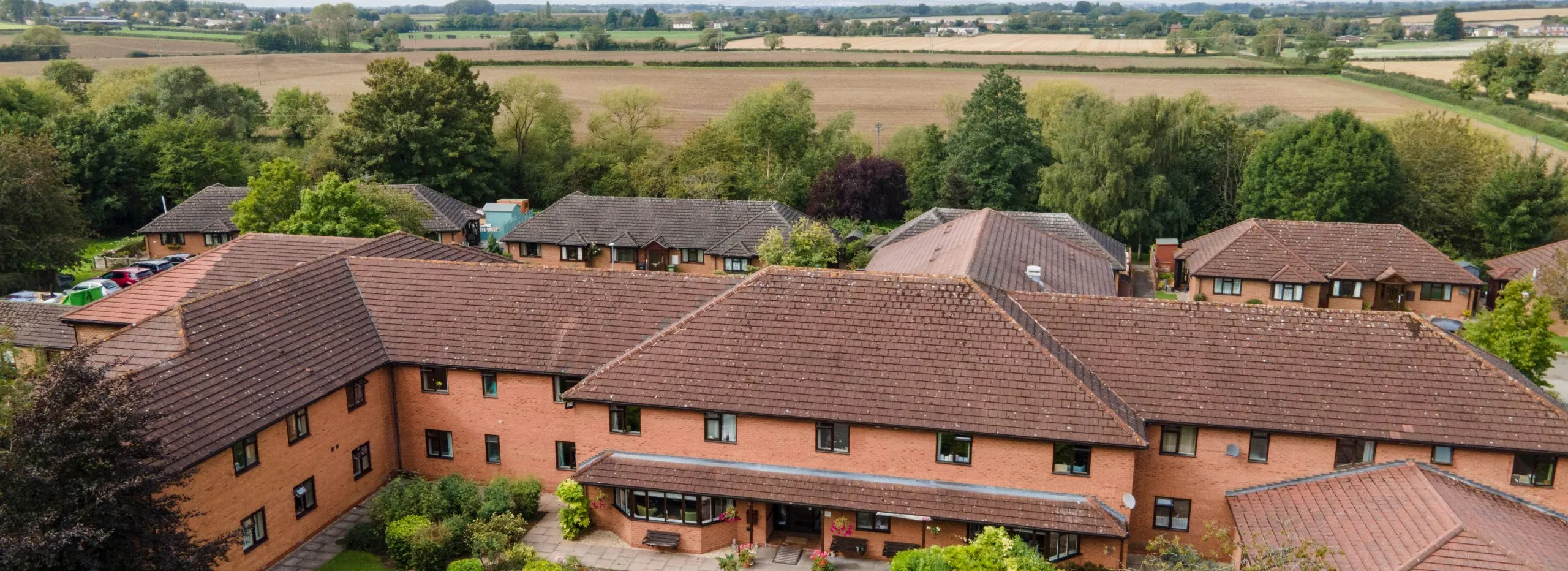 Aerial view of The Orchards Residential Home surrounded by green fields