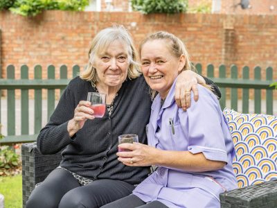 Residents enjoying drinks in a garden setting