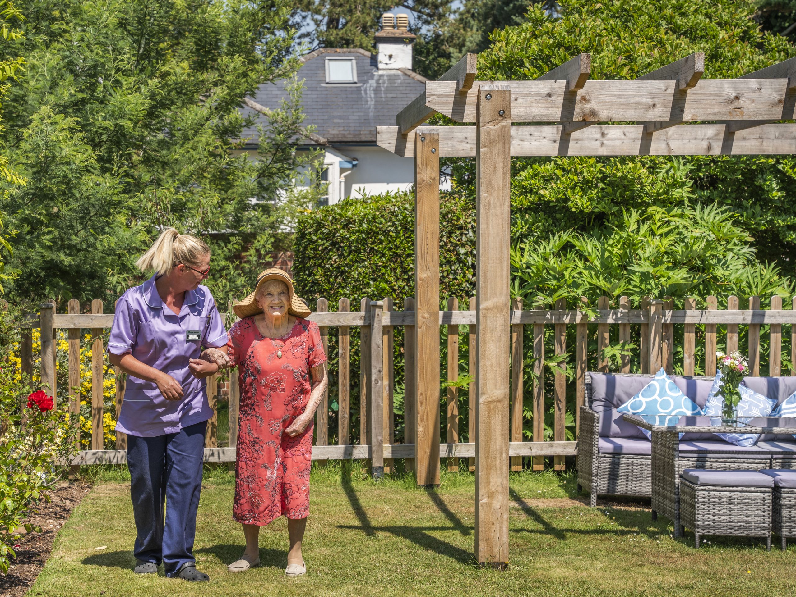 Staff member assisting a resident in the garden
