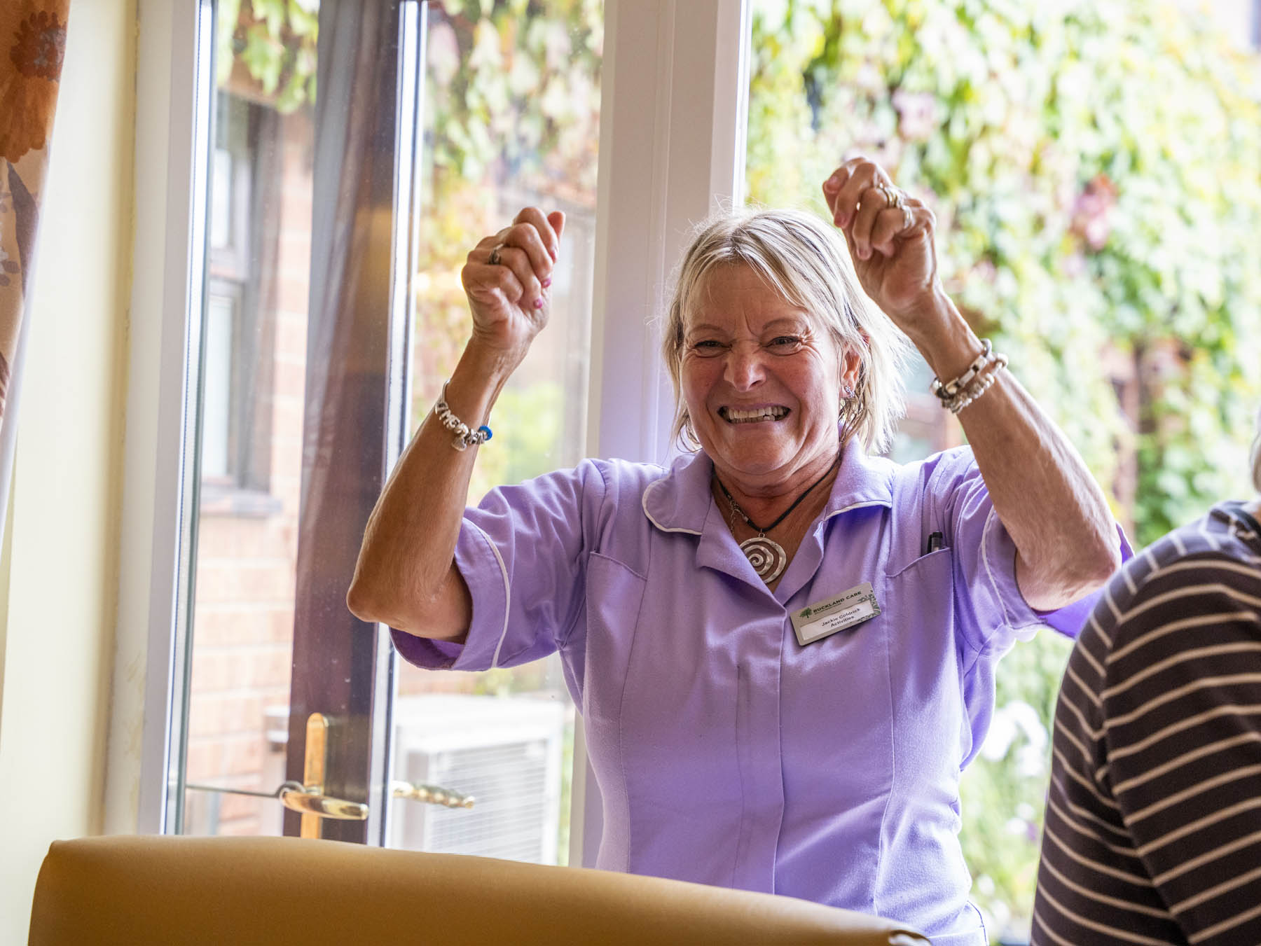 Staff member joyfully engaging with residents