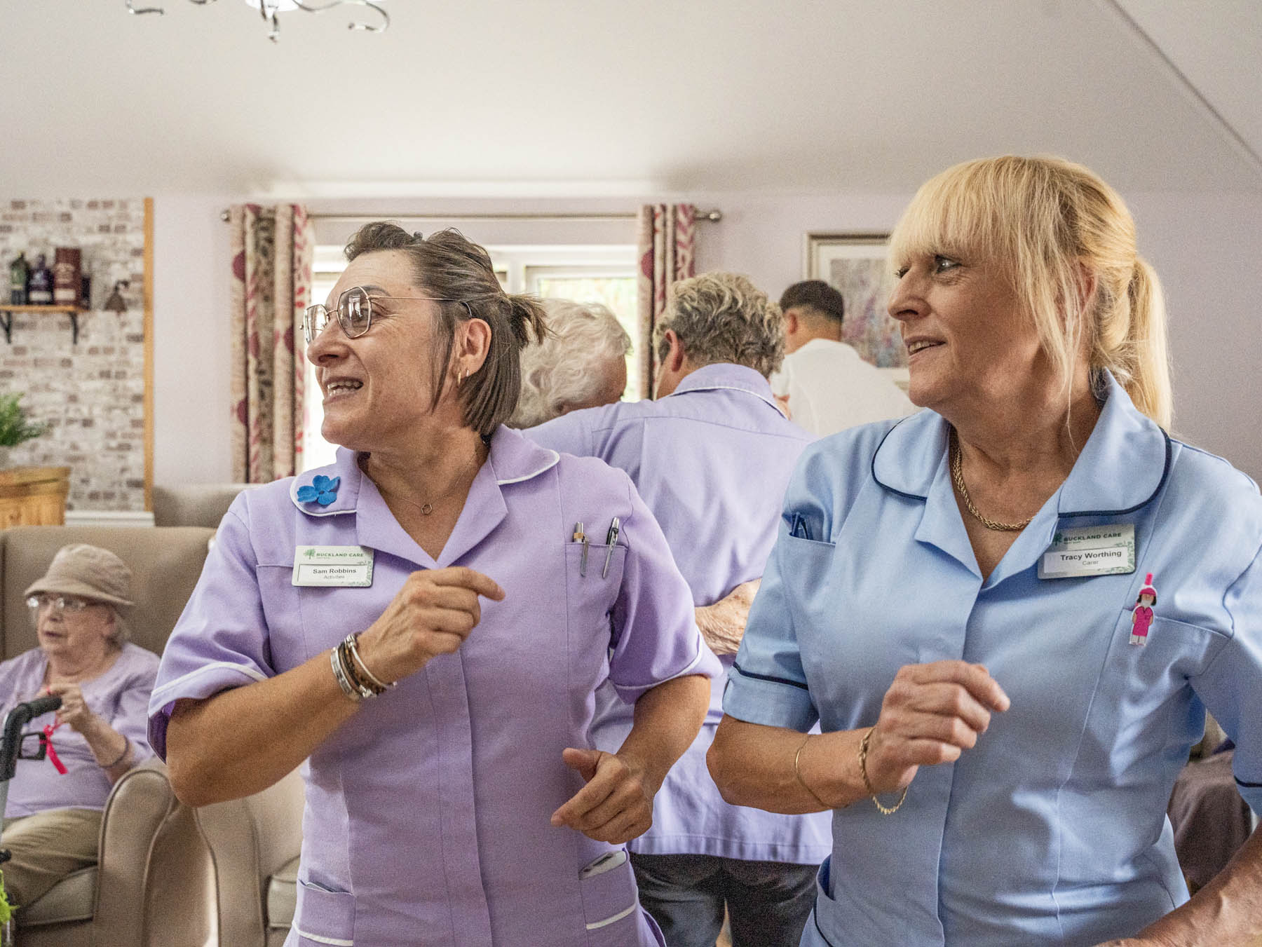 Staff engaging with residents in a lively gathering