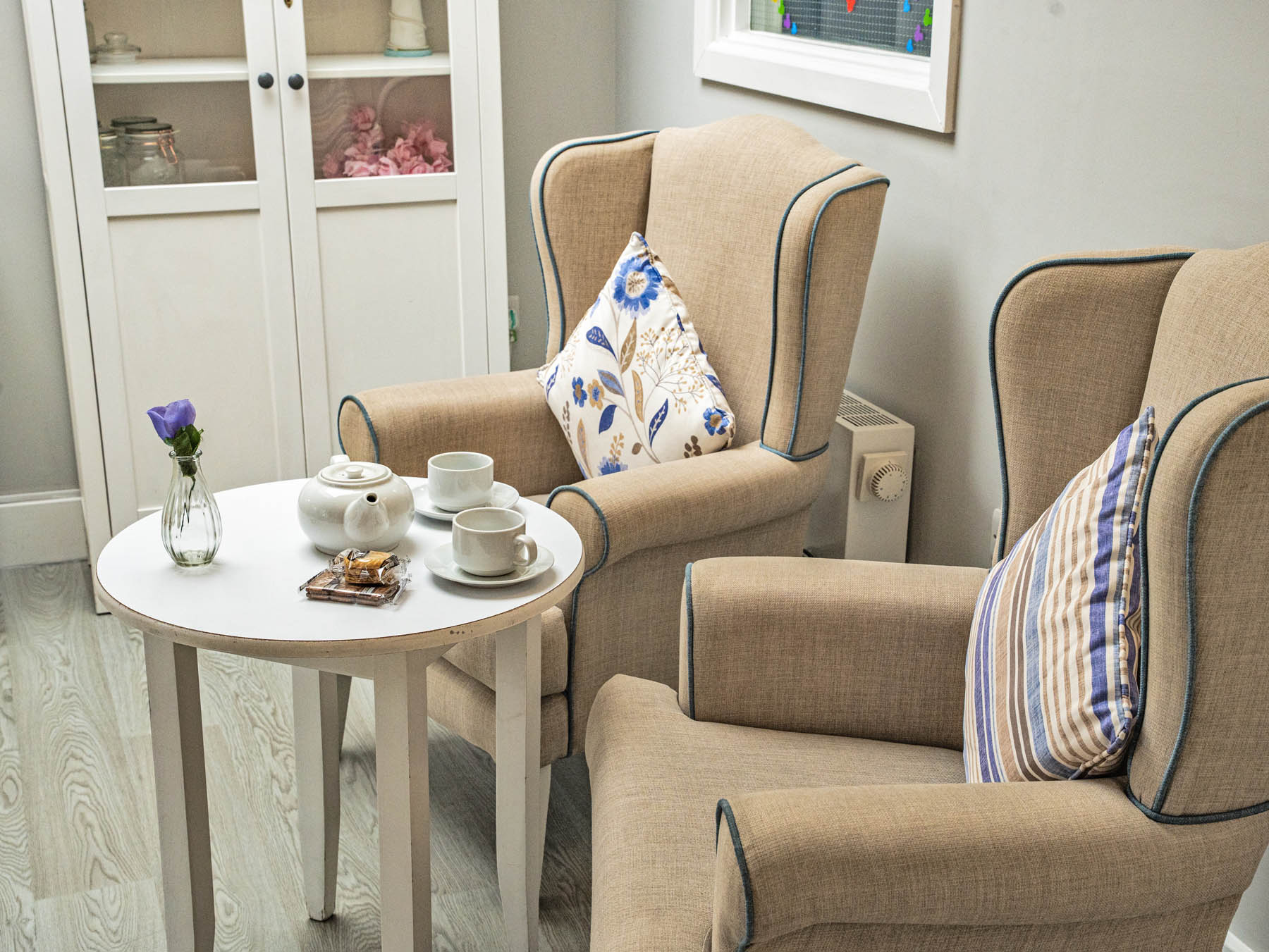 Cozy seating area with tea set and decorative pillows