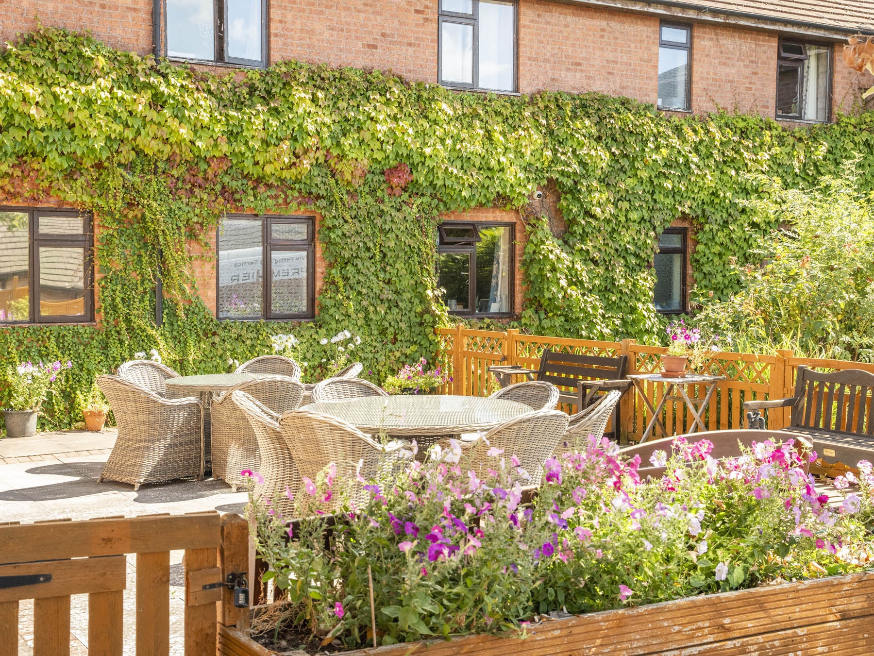 Outdoor patio area with seating and flowers
