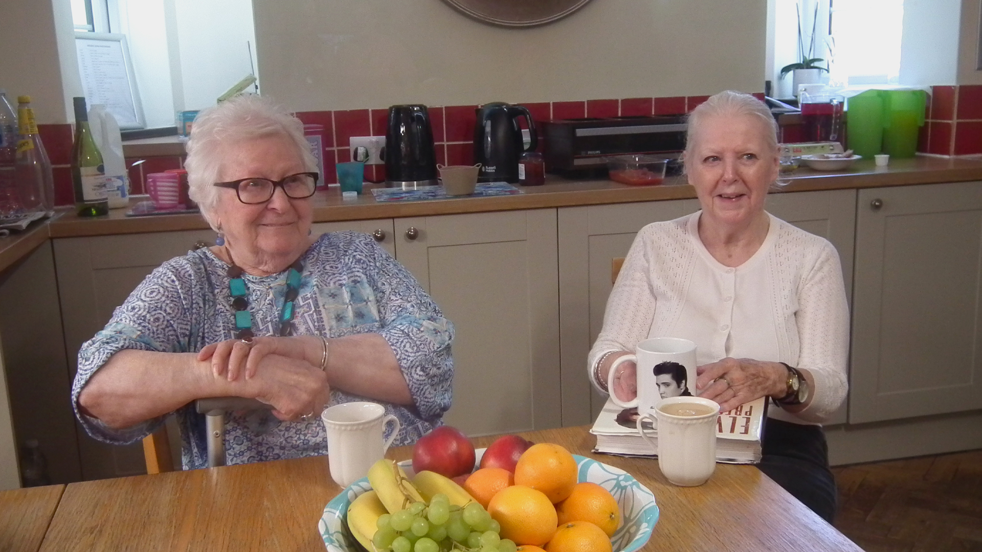 Two residents enjoying time together in a cozy kitchen setting