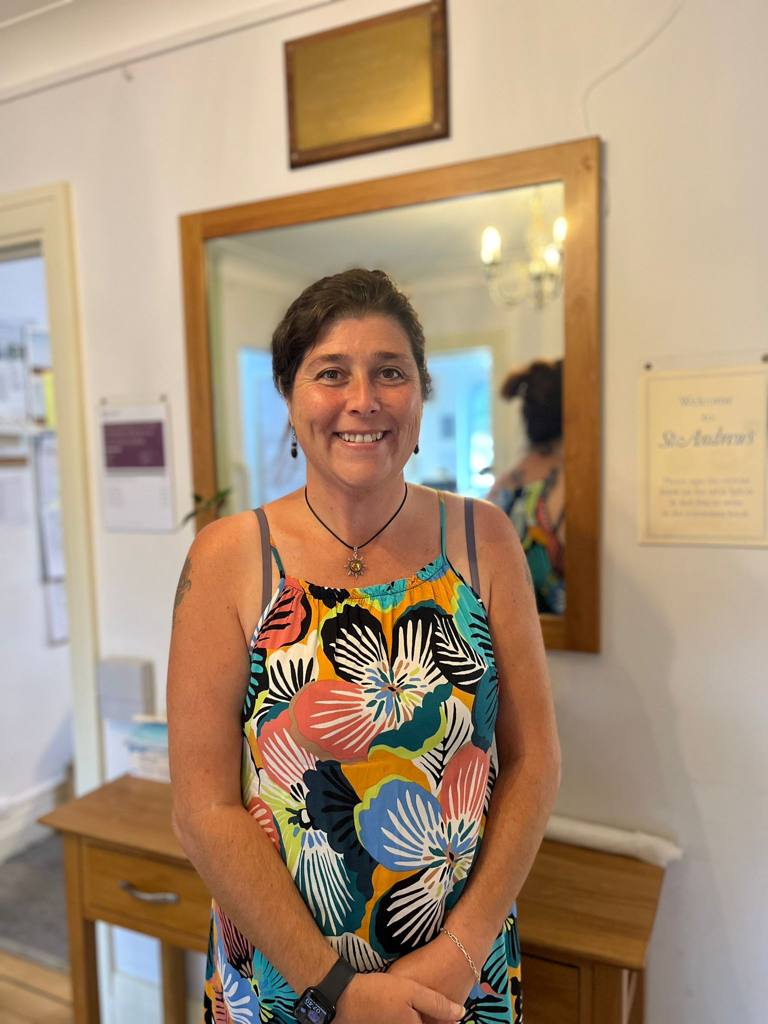 Staff member smiling in the facility's lobby