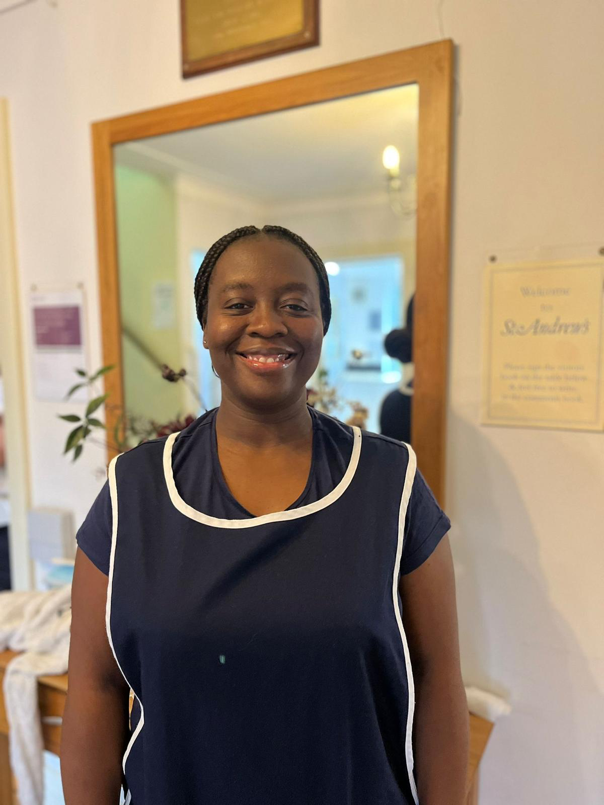 Staff member smiling in a care home environment