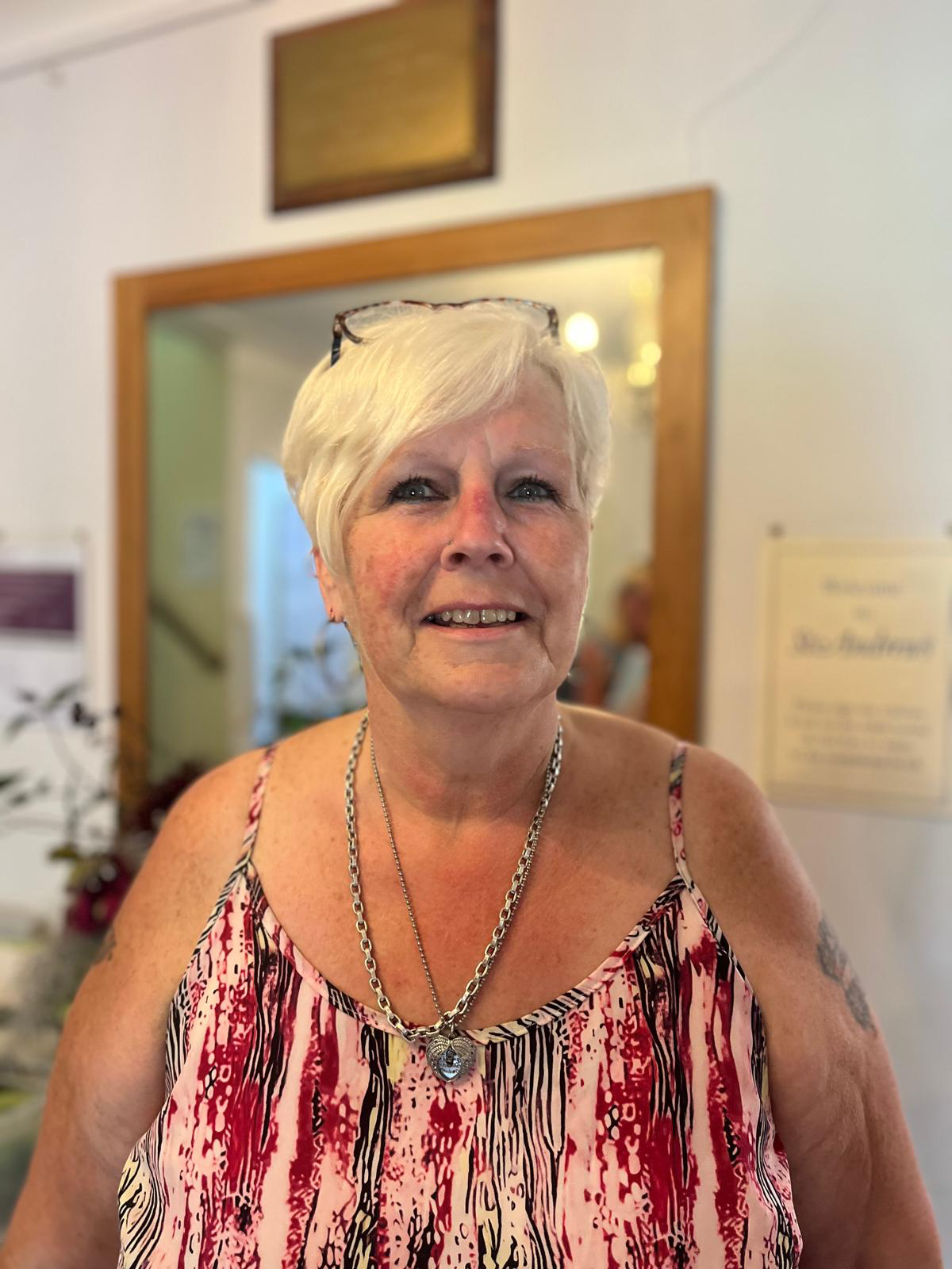 Resident smiling in a vibrant common area