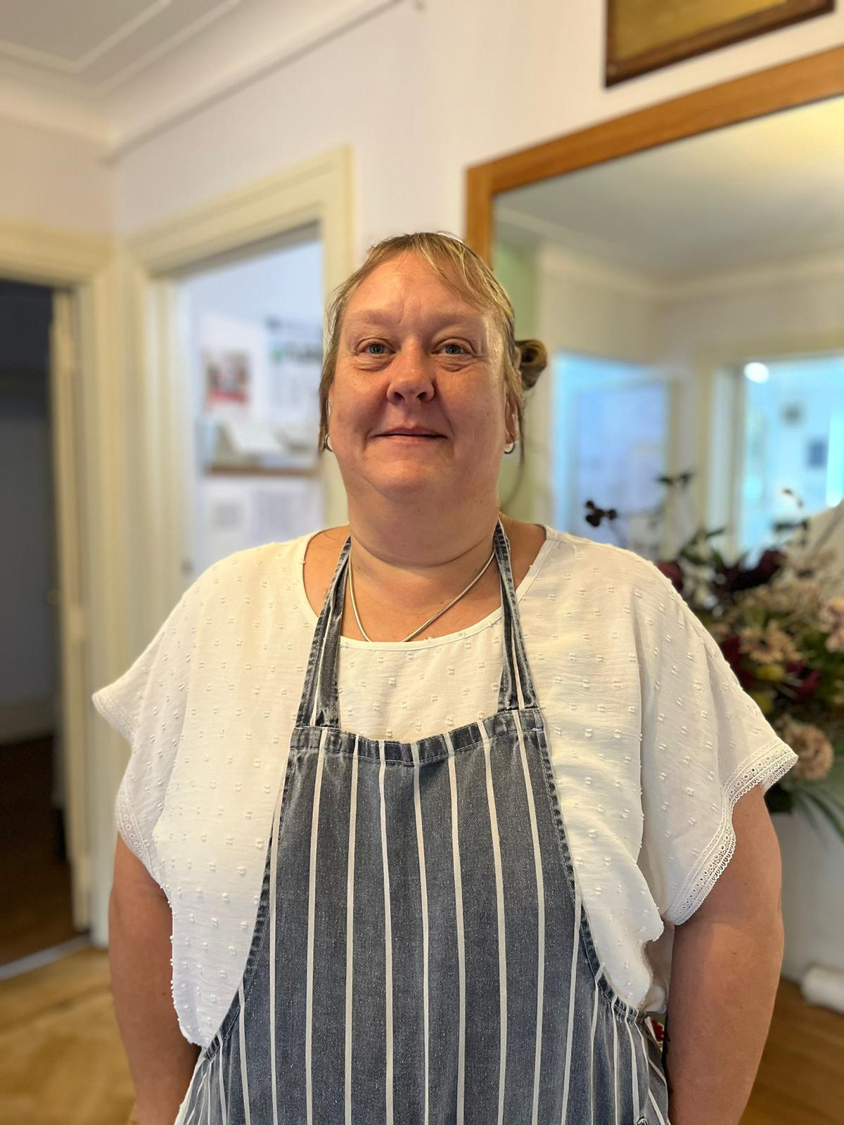 Staff member smiling in a care home environment