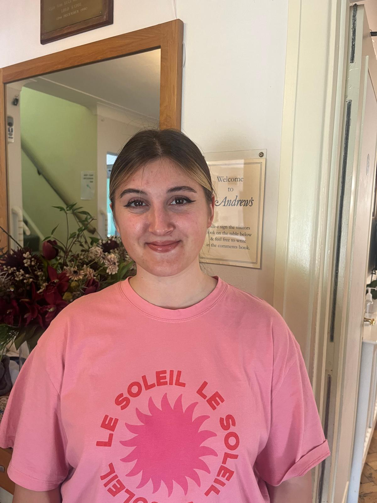 Staff member standing in a welcoming lobby area