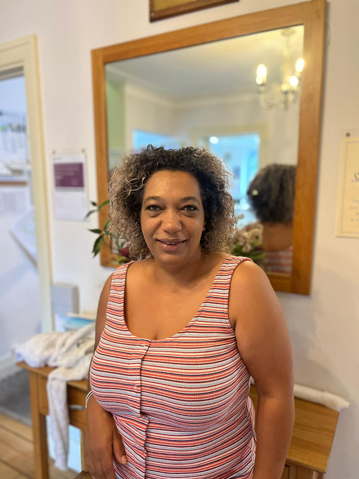 Staff member smiling in a welcoming facility interior