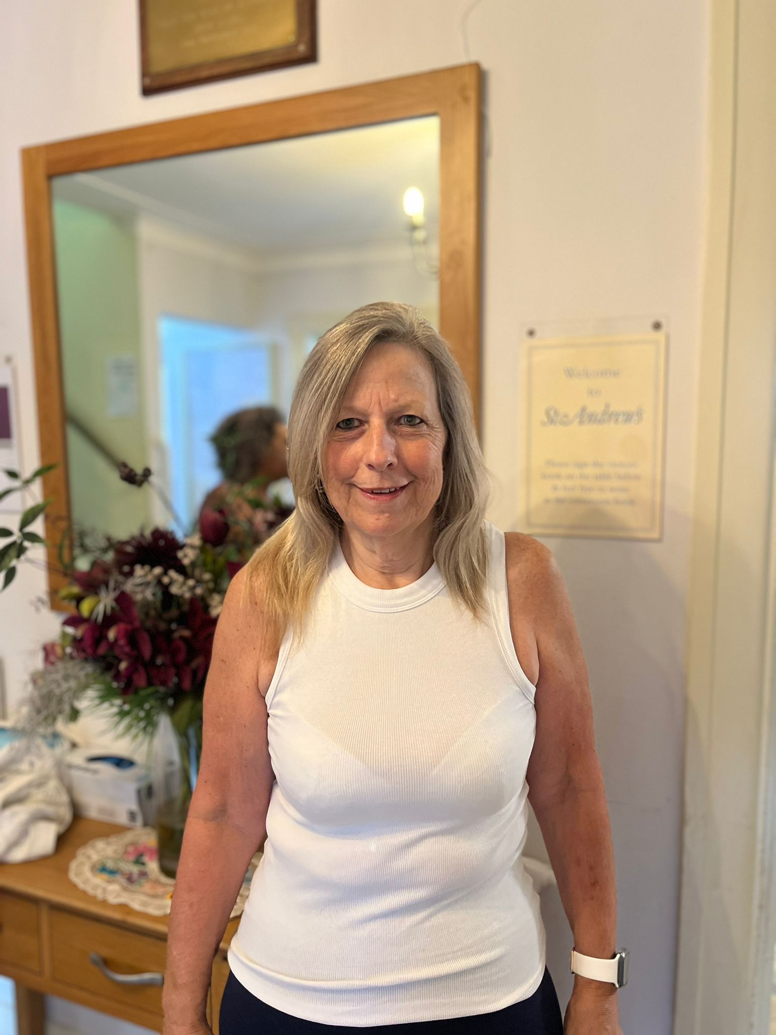 Female resident smiling in the facility's interior