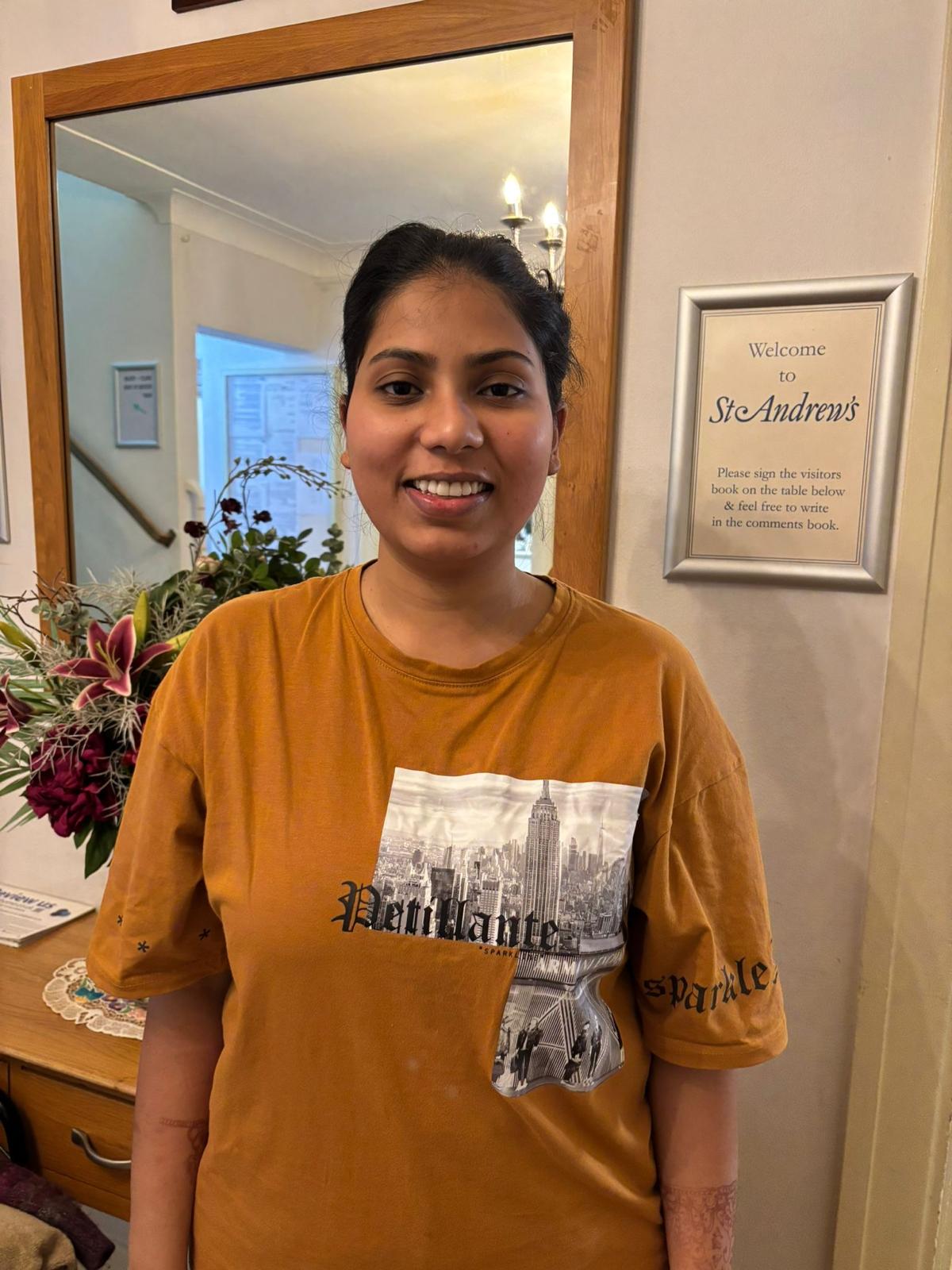 Staff member smiling in the facility foyer