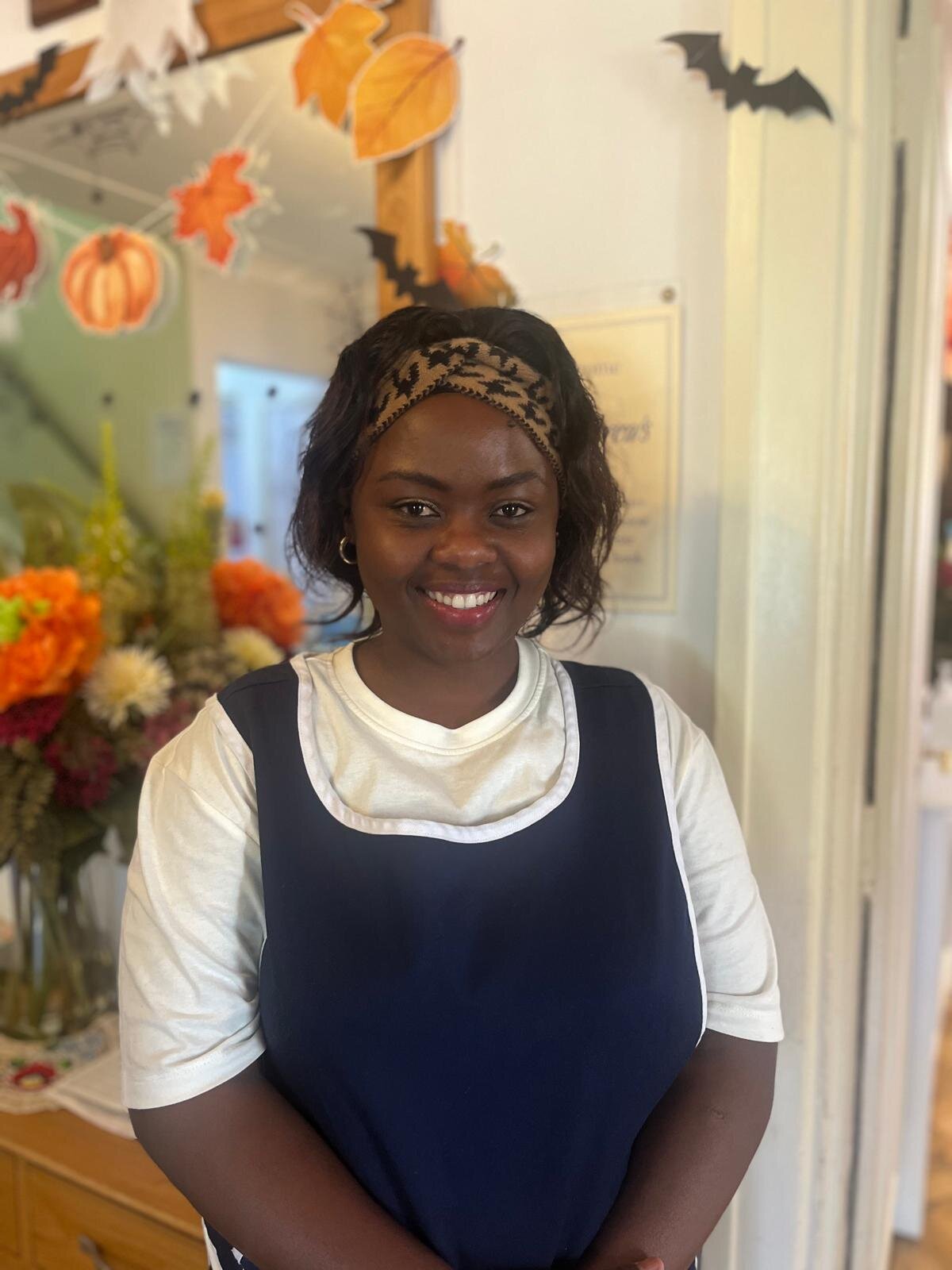 Staff member smiling in a decorated common area
