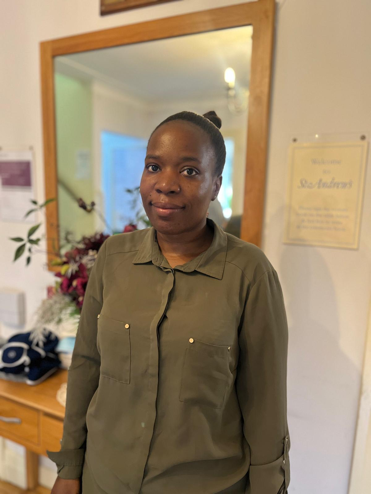Staff member in a warm facility interior setting