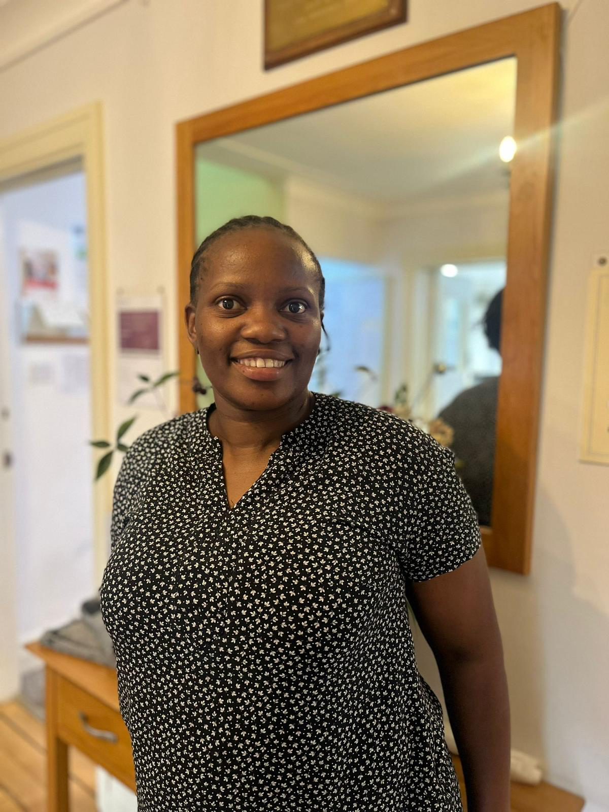 A staff member smiling in the facility interior