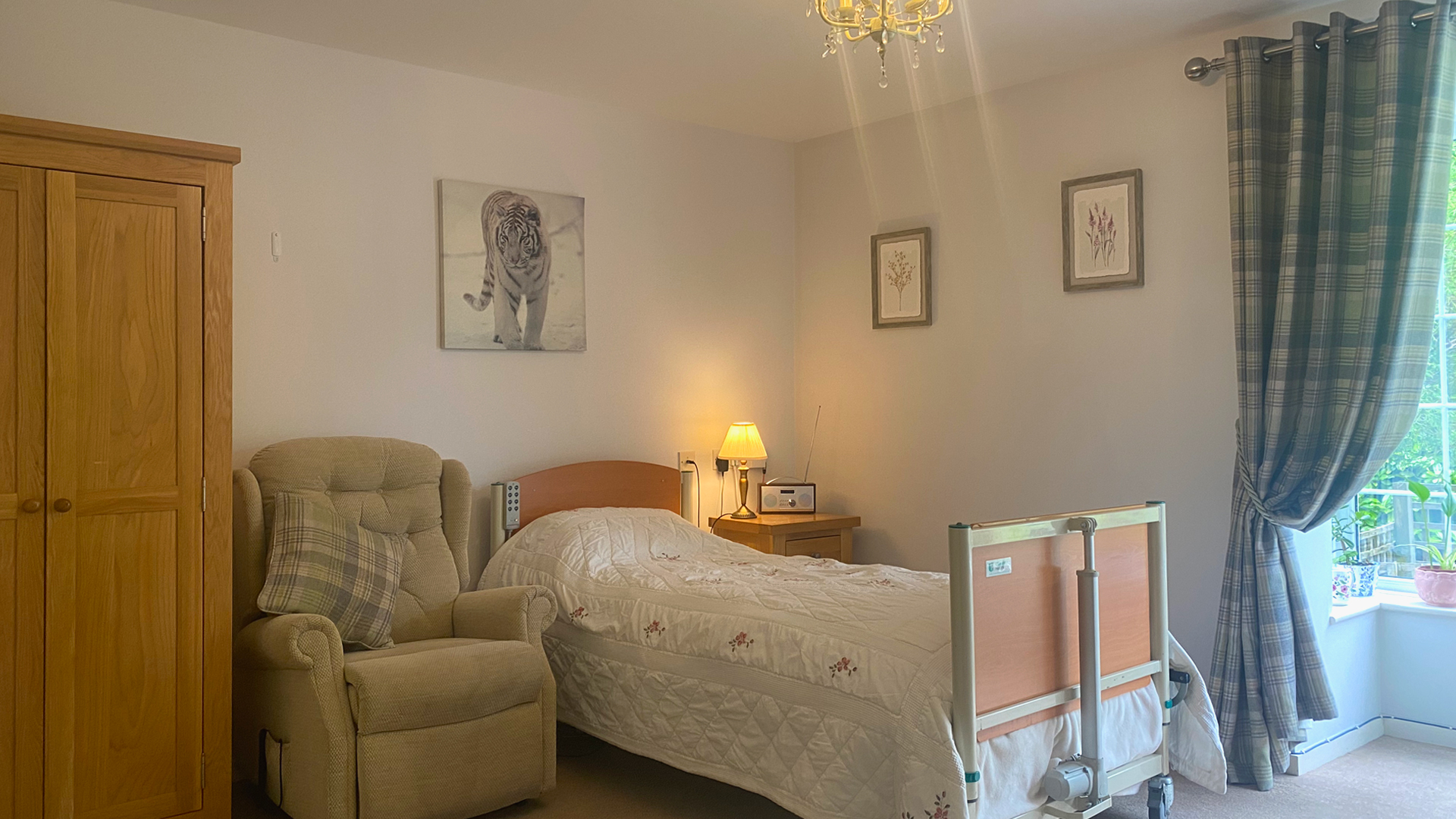 A cozy resident room with a bed and chair