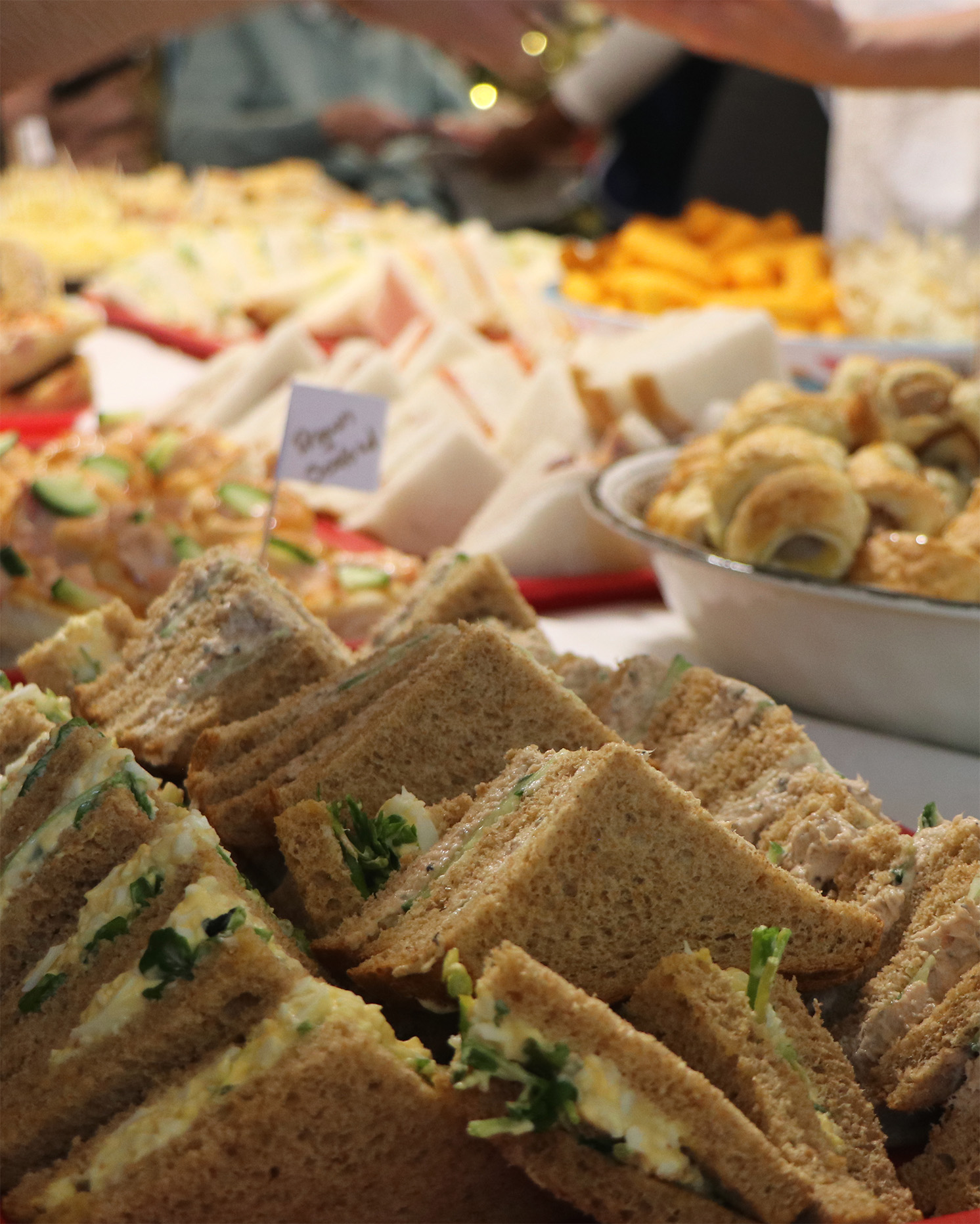 Platter of assorted sandwiches at a gathering