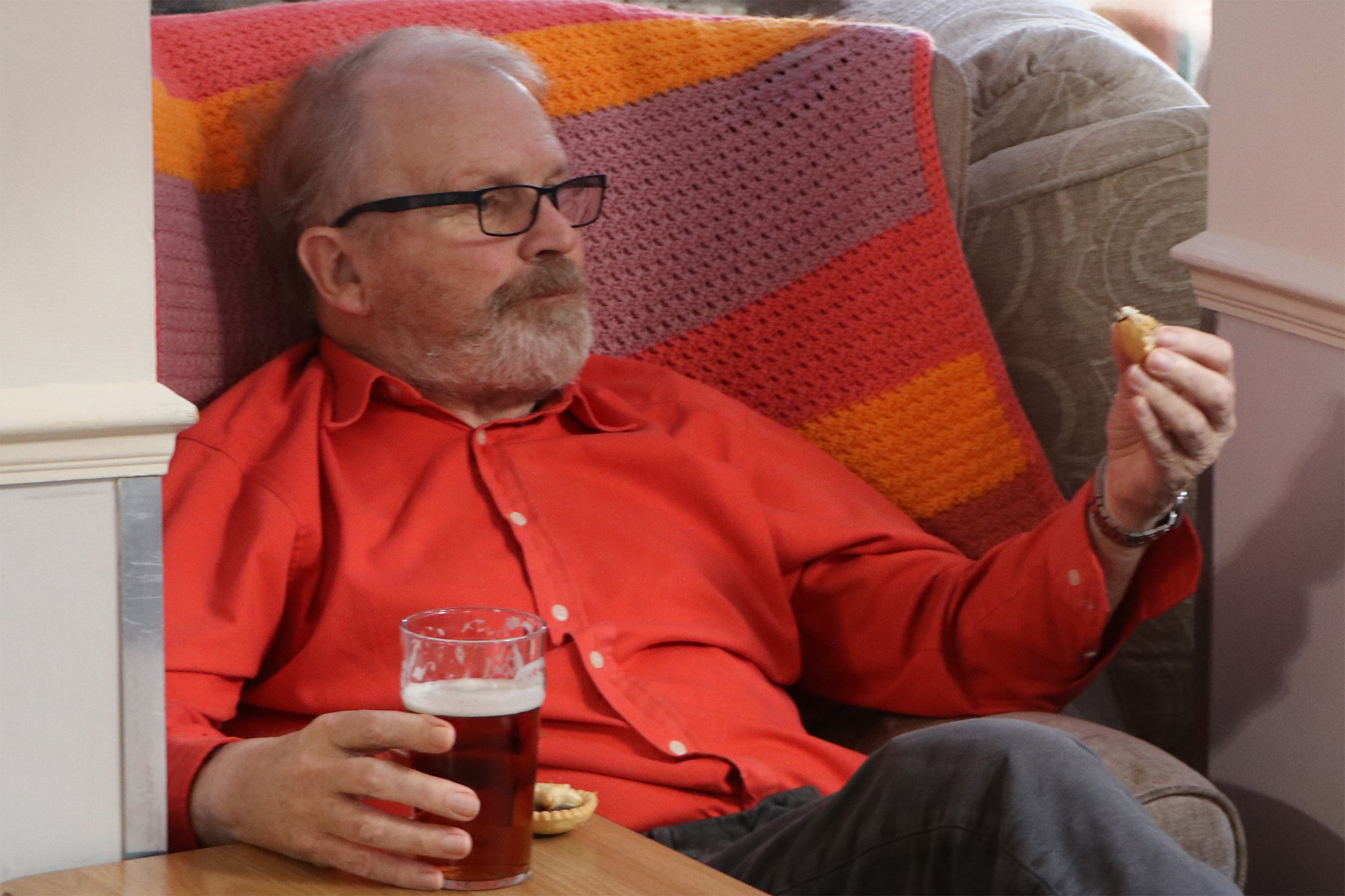 Resident enjoying snacks and a drink in a cozy common area