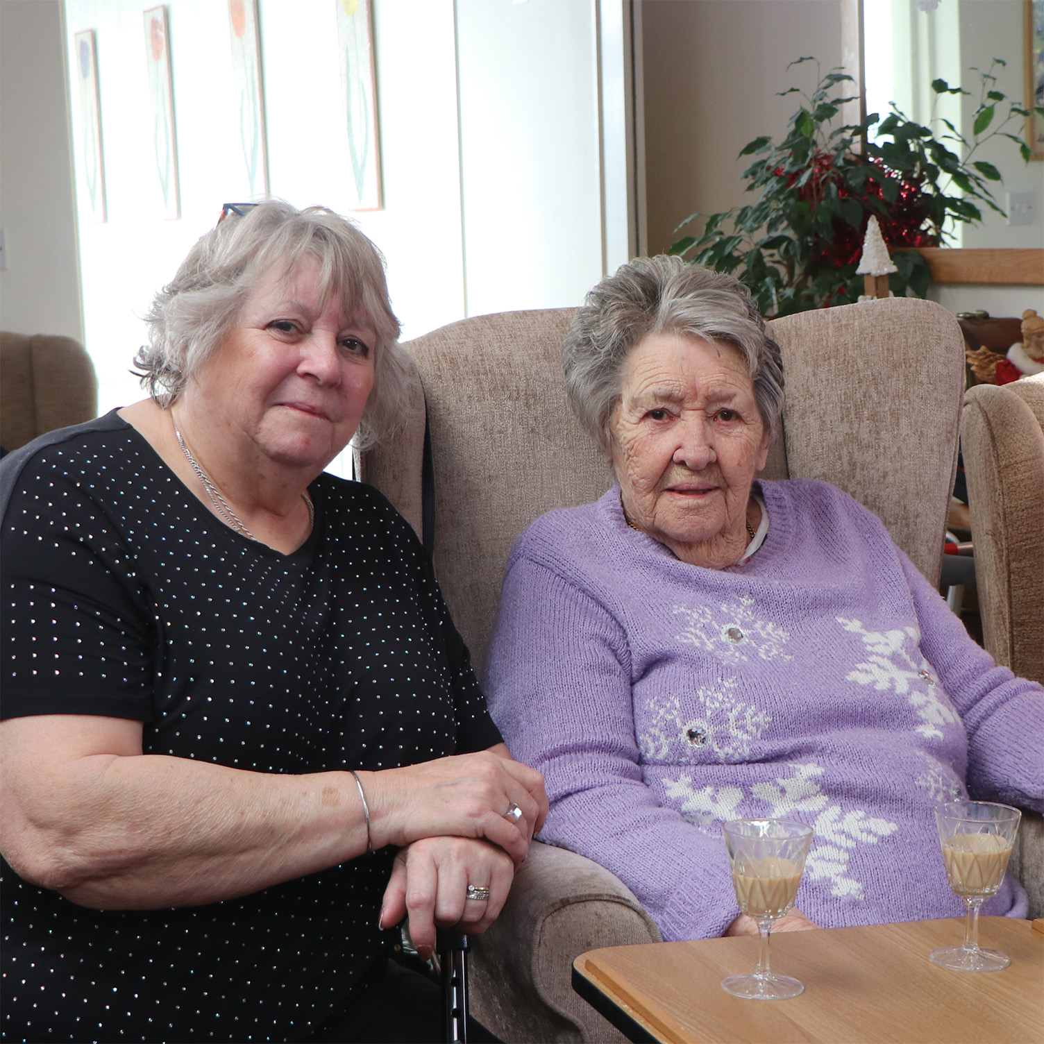 Two residents enjoying time together in a common area