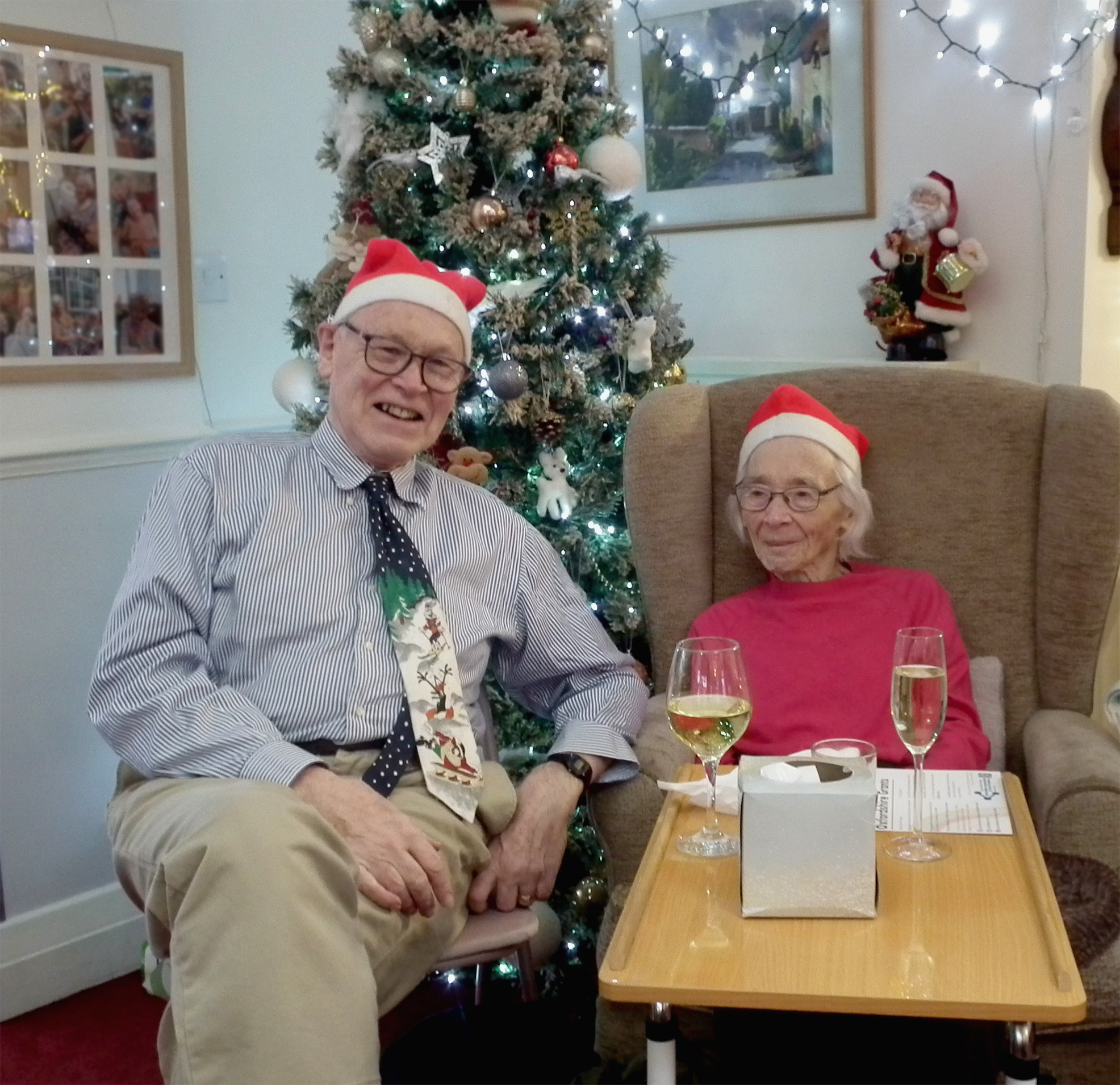 Two residents celebrating with drinks in a festive setting