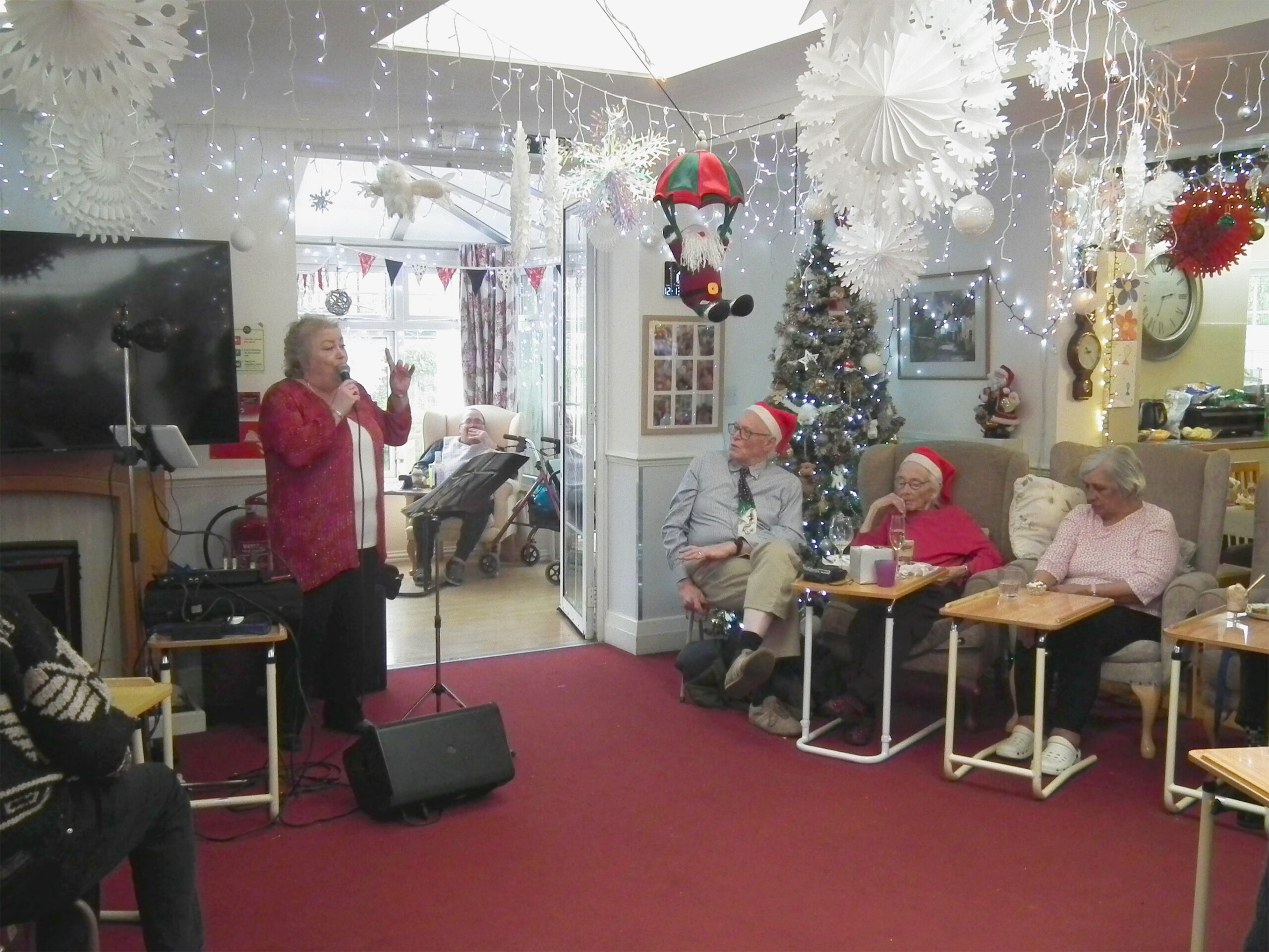 Residents enjoying music performance in a festive common area