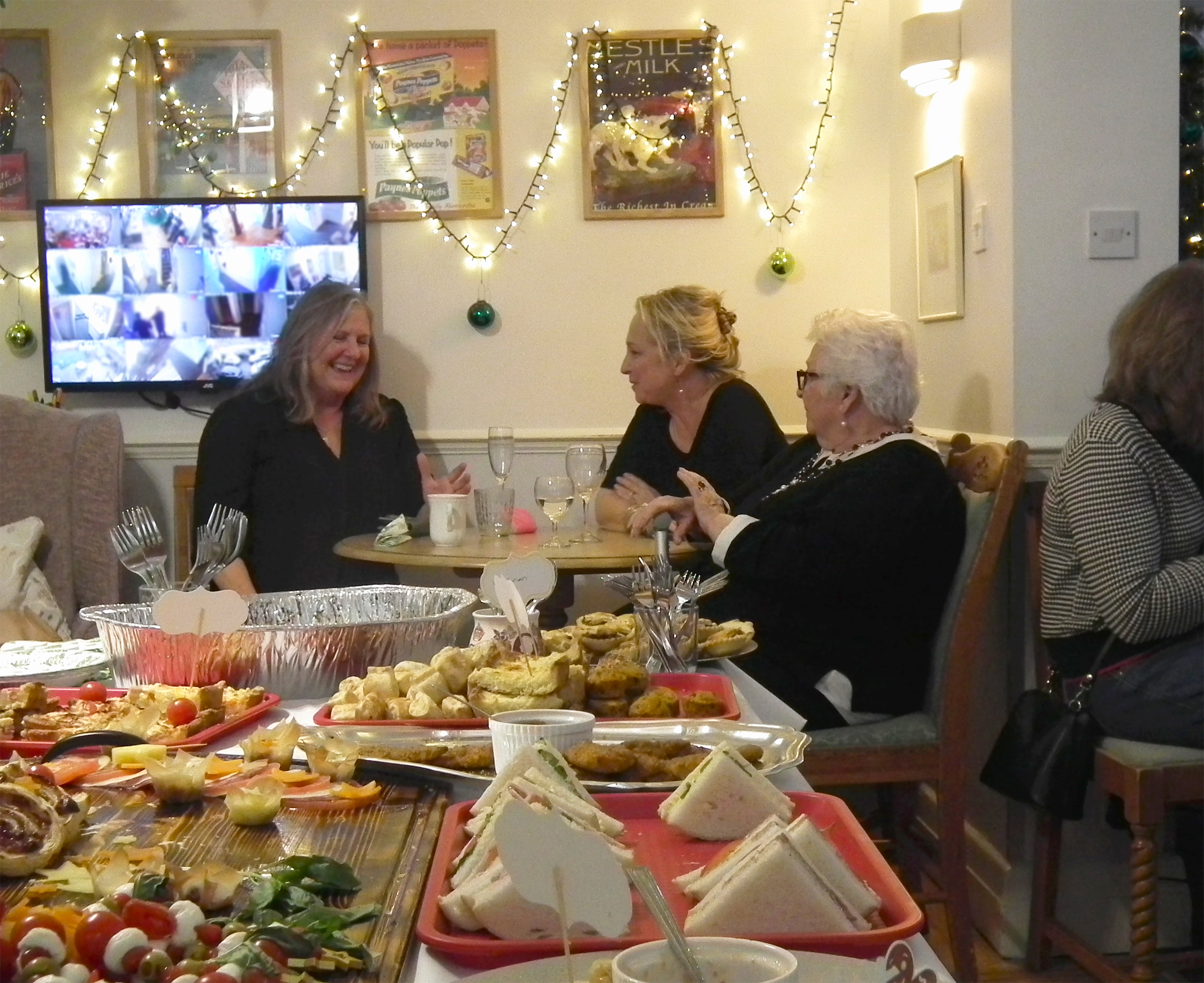 Three women enjoying conversation in a dining setting.