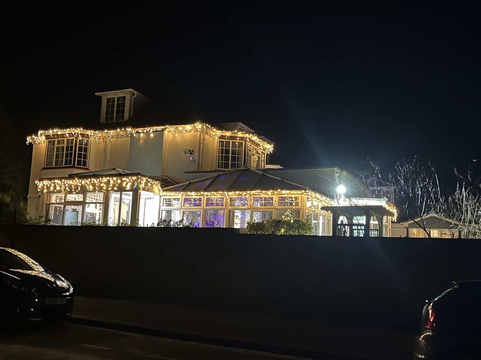 Exterior of the assisted living facility adorned with lights